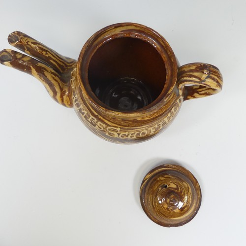 143 - A late 19thC slipware marriage Teapot, with double spout and cover, chips to rim, inscribed for 'Mr ... 