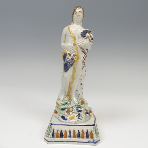 153 - A 19thC prattware figure of Summer, modelled with cornucopia cluthed in arm, raised on plinth base w... 