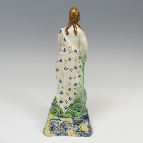 159 - An early 19thC pearlware figure of Spring, decorated in prattware palette, modelled in typical stanc... 