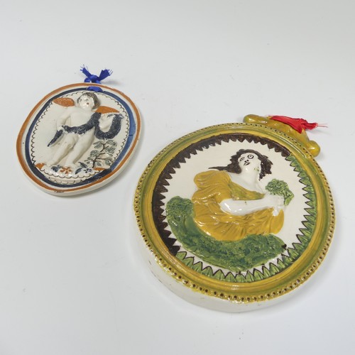 161 - A 19thC pearlware wall hanging Plaque, ovular in shape, depicting a moulded relief of a woman at the... 