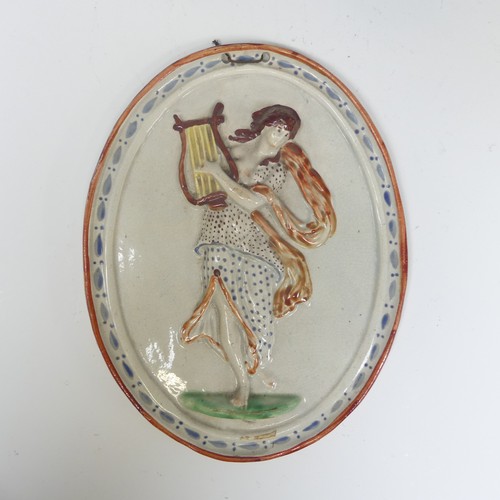 162 - An early 19thC pearlware wall Plaque, depicting a classical figure, possibly Erato, in moulded relie... 