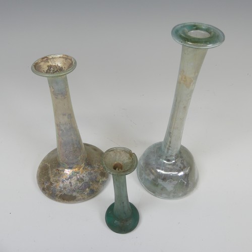 169 - A Roman iridescent glass Ungeumtarium, with flat bulbous base and tapering neck, H 19.5cm, together ... 