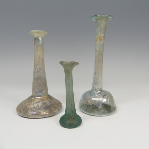 169 - A Roman iridescent glass Ungeumtarium, with flat bulbous base and tapering neck, H 19.5cm, together ... 