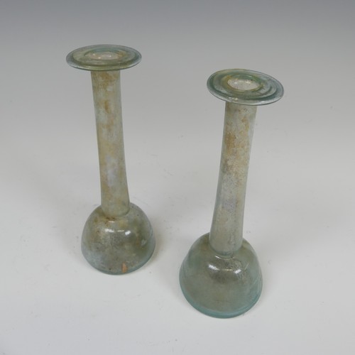 170 - A Roman iridescent glass Unguentarium, with flat bulbous body and long tapering neck, some traces of... 