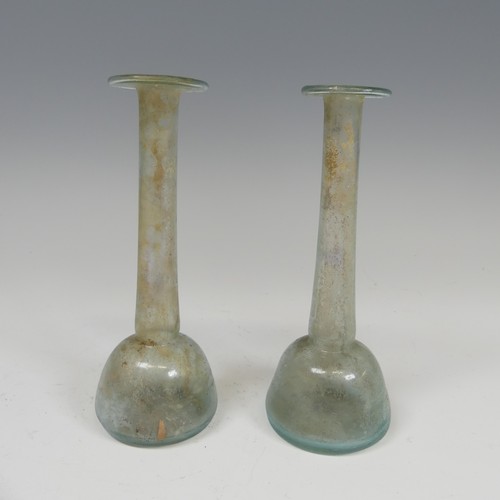 170 - A Roman iridescent glass Unguentarium, with flat bulbous body and long tapering neck, some traces of... 