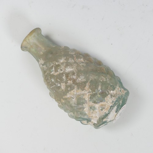 172 - A Roman pale green glass pine cone Flask, c. 2nd - 3rd century AD, the body blown in a two part moul... 