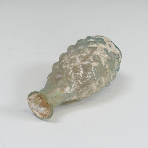 172 - A Roman pale green glass pine cone Flask, c. 2nd - 3rd century AD, the body blown in a two part moul... 