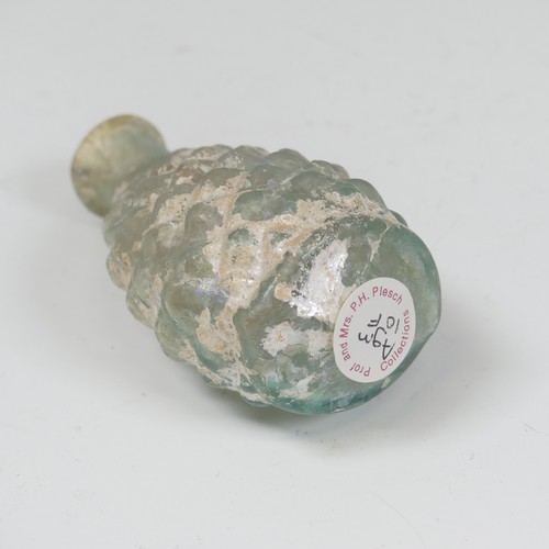 172 - A Roman pale green glass pine cone Flask, c. 2nd - 3rd century AD, the body blown in a two part moul... 