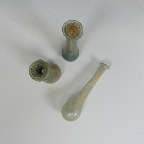 175 - A small Roman iridescent glass Unguentarium, of bulbous base and flared rim, H 7.5cm, together with ... 