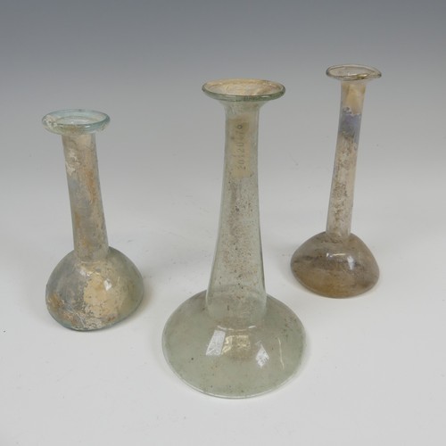 191 - A group of three Roman glass Ugeuntariums, each with bulbous base and long tapering necks, c. 2nd ce... 