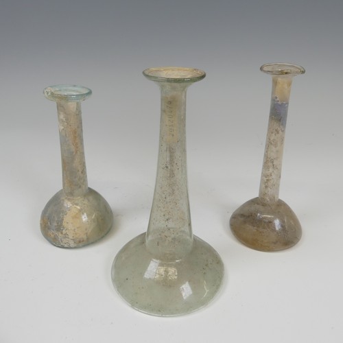 191 - A group of three Roman glass Ugeuntariums, each with bulbous base and long tapering necks, c. 2nd ce... 