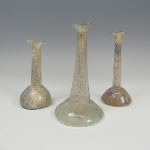 191 - A group of three Roman glass Ugeuntariums, each with bulbous base and long tapering necks, c. 2nd ce... 