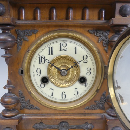 310 - A late 19th century continental walnut Mantel Clock, movement marked with crossed arrows and label '... 