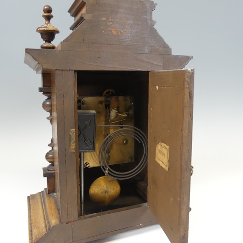 310 - A late 19th century continental walnut Mantel Clock, movement marked with crossed arrows and label '... 