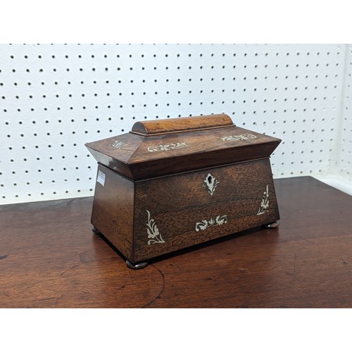 366 - An antique Regency style rosewood and mother of pearl sarcophagus tea Caddy, fitted interior and rai... 