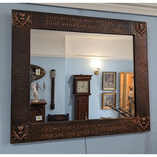 365 - An Arts and Crafts Scottish school copper Mirror, hammered frame with stylised thistles to each corn... 