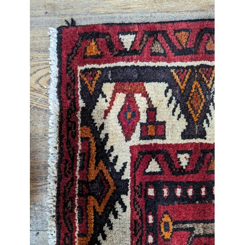 650 - Tribal rugs; a good Persian Hamadan red-ground carpet, wool pile on cotton base, 266cm x 173cm, good... 