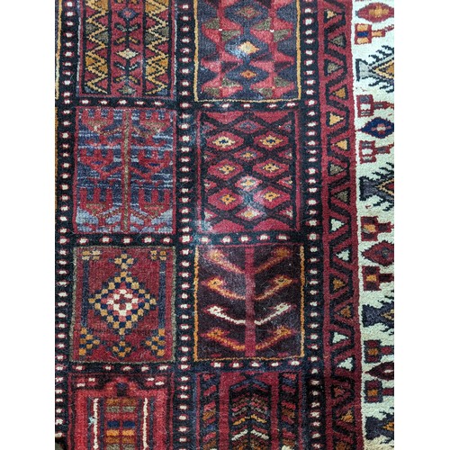 650 - Tribal rugs; a good Persian Hamadan red-ground carpet, wool pile on cotton base, 266cm x 173cm, good... 