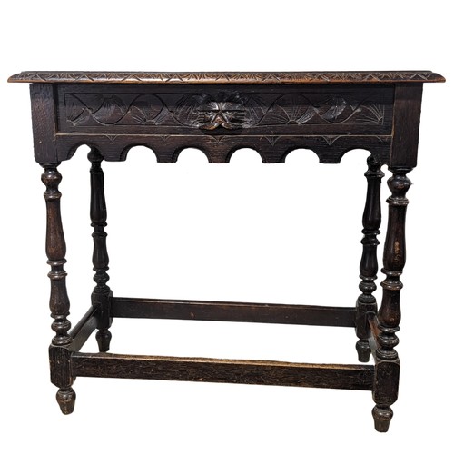 355 - An antique 18th century style oak side Table, rectangular plank top above carved green man drawer, r... 