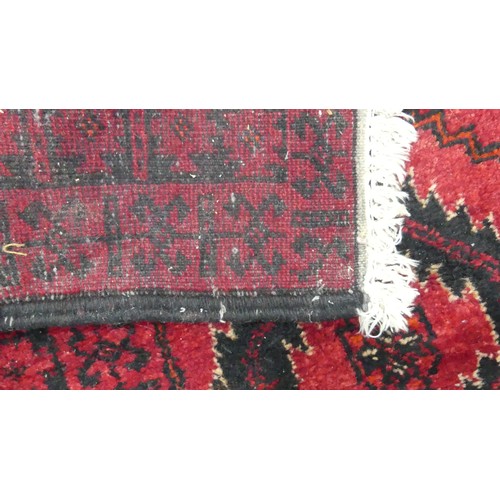 640 - Tribal Rugs; a red ground Afghan rug, wool pile on cotton base, 179cm x 94.5cm, good overall conditi... 