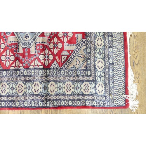 641 - Tribal Rugs; a finely knotted red ground Persian rug, wool pile on cotton base, 280cm x 176cm, pile ... 