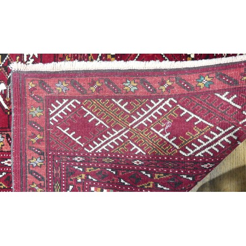 642 - Tribal Rugs; a good finely knotted red ground Turkomen carpet, wool pile on wool base, three rows of... 