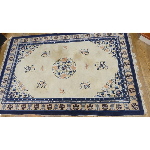 639 - Hand-knotted Rugs; an old Chinese cream ground carpet, the centre with floral sprays and butterflies... 