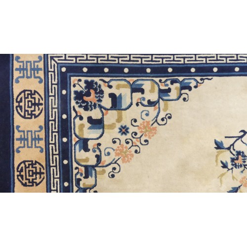 639 - Hand-knotted Rugs; an old Chinese cream ground carpet, the centre with floral sprays and butterflies... 