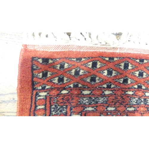 646 - Tribal rugs; an finely-knotted red ground Bokhara rug, wool pile on a cotton base, 170cm x 98cm, goo... 