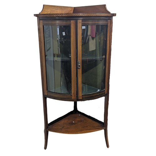 381 - An Edwardian mahogany bow-fronted corner display Cabinet, with chequer inlay raised on splayed taper... 