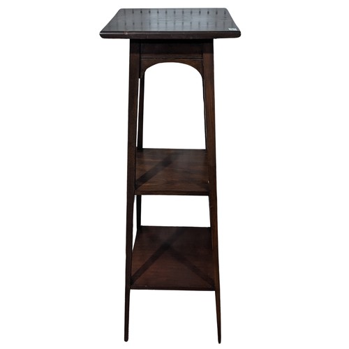 328 - An Arts and Crafts mahogany square Torchere / Plant Stand, three shelves raised on square tapering l... 