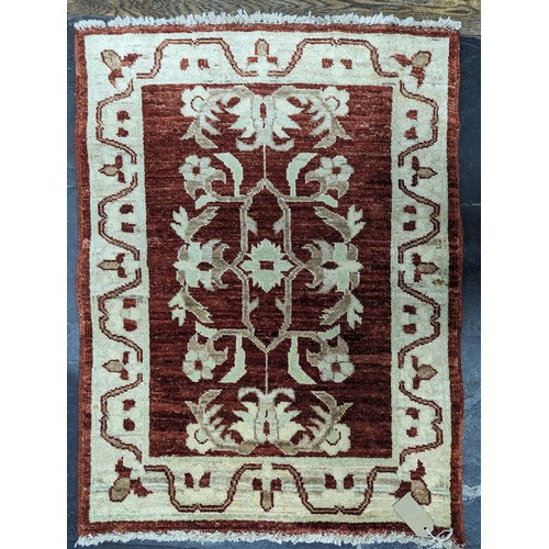 638 - Tribal Rugs; a small silk Kashmiri Mat, 72cm x 30cm, together with two other small rugs, one with ev... 