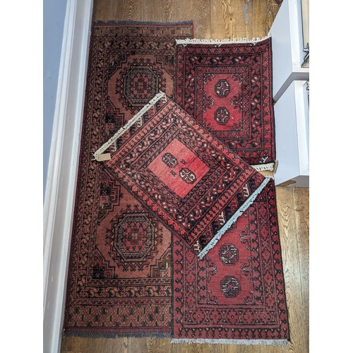 637 - Tribal Rugs; a small red ground Afghan runner, wool pile on wool base, 160cm x 67cm, together with t... 