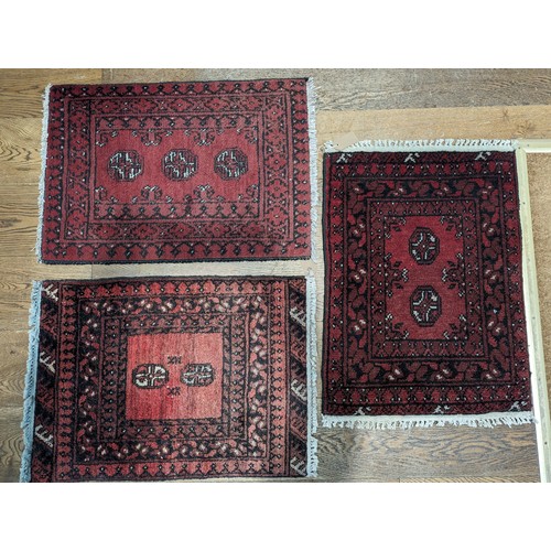 637 - Tribal Rugs; a small red ground Afghan runner, wool pile on wool base, 160cm x 67cm, together with t... 