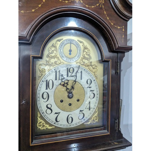 304 - An inlaid mahogany Longcase Clock with arched brass dial, silvered chapter ring with arabic numerals... 