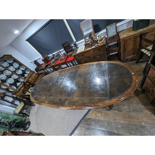 619 - An unusual Victorian oval Library Table / boardroom Table, with gilt tooled leather skived top, rais... 