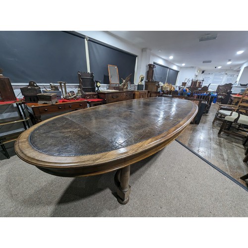 619 - An unusual Victorian oval Library Table / boardroom Table, with gilt tooled leather skived top, rais... 