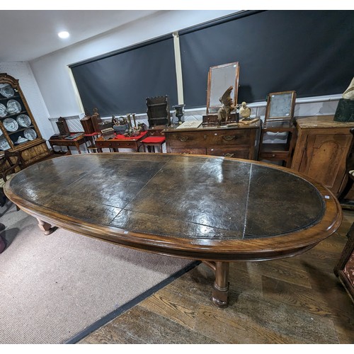 619 - An unusual Victorian oval Library Table / boardroom Table, with gilt tooled leather skived top, rais... 