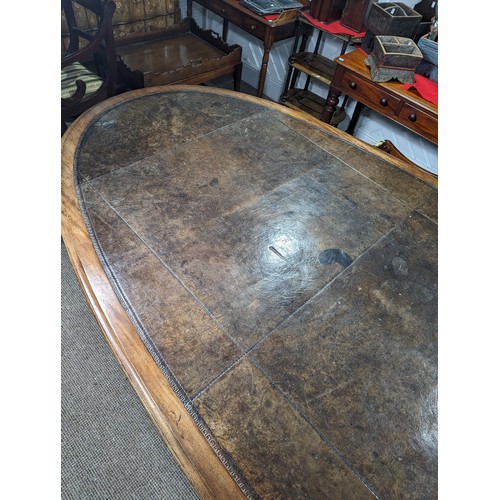 619 - An unusual Victorian oval Library Table / boardroom Table, with gilt tooled leather skived top, rais... 