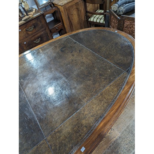 619 - An unusual Victorian oval Library Table / boardroom Table, with gilt tooled leather skived top, rais... 