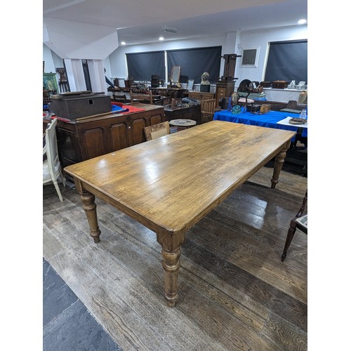 358 - An early 20th century oak Farmhouse Kitchen Table, five plank rectangular moulded top raised on four... 