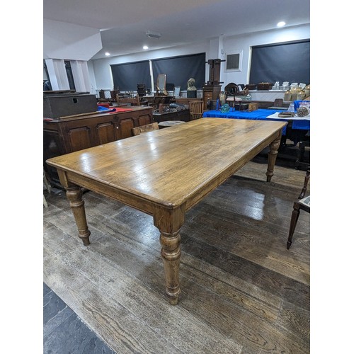 358 - An early 20th century oak Farmhouse Kitchen Table, five plank rectangular moulded top raised on four... 