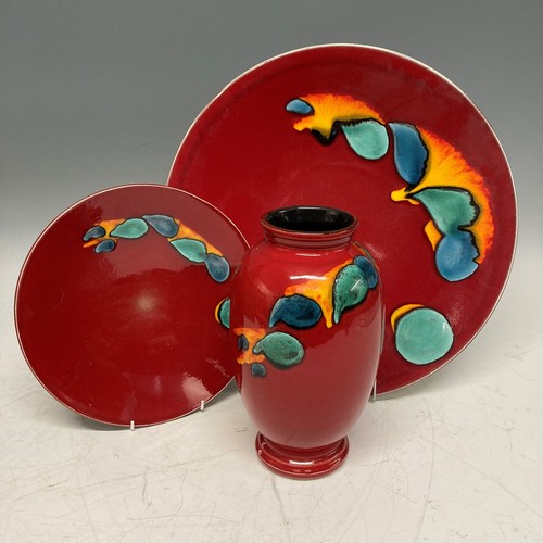 93 - A large Poole Pottery Volcano Charger, D 41 cm, together with another smaller D 26 cm and a Vase(3)... 