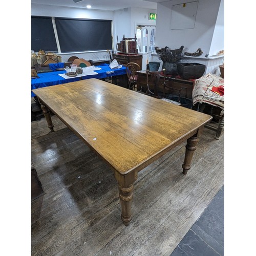 358 - An early 20th century oak Farmhouse Kitchen Table, five plank rectangular moulded top raised on four... 