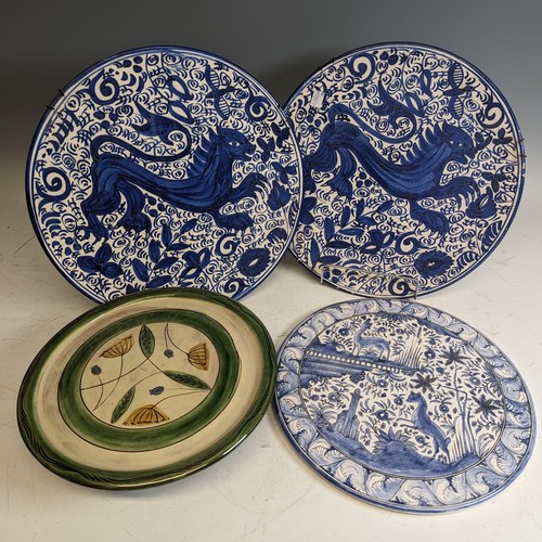 119 - A pair of antique blue and white pottery Wall Plates, decorated with central animal enclosed with fo... 