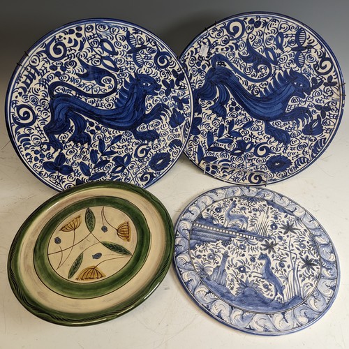 119 - A pair of antique blue and white pottery Wall Plates, decorated with central animal enclosed with fo... 