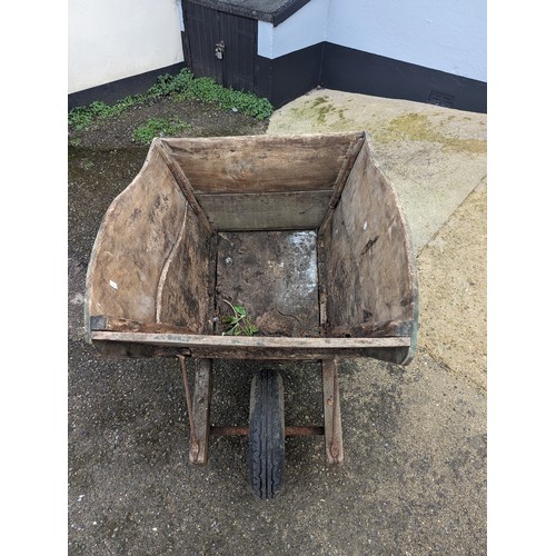 652 - A weathered decorative large wooden garden Wheelbarrow, note lots of wear, W 77 cm x H 89 cm x D 155... 