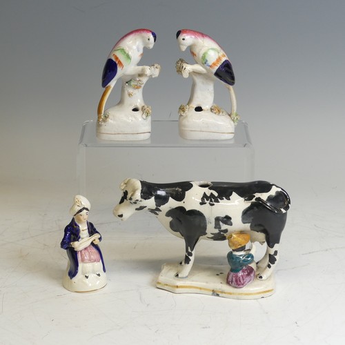 106 - An antique Staffordshire Cow Creamer, modelled as being milked, lacks cover, damaged, H 13cm, togeth... 