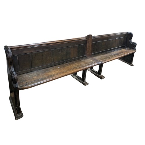 641 - A large oak Victorian double church Pew, decorated with carvings and scrolls, constructed from two s... 