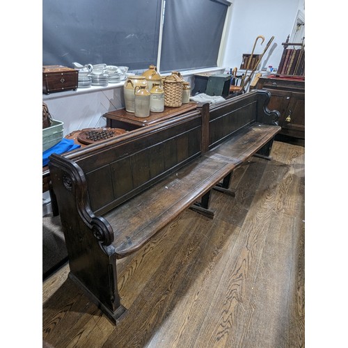 641 - A large oak Victorian double church Pew, decorated with carvings and scrolls, constructed from two s... 